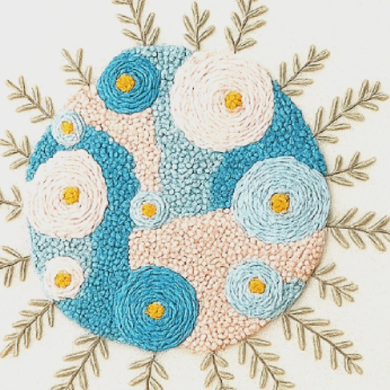 Decorative rug with blue and beige circular patterns and yellow centers, surrounded by gold leaves on a white background.