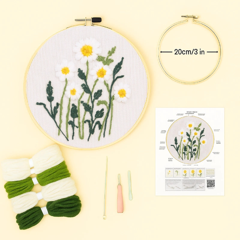 Embroidery hoop with floral design, embroidery thread, and pattern guide on a light yellow background