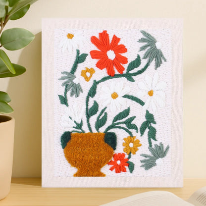 This pattern features a golden vase filled with red, white, and yellow flowers, their green leaves arching gracefully to create a fresh and elegant floral composition.