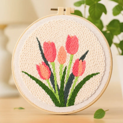 This punch needle artwork features a bouquet of tulips in soft pink and coral tones, symbolizing love, renewal, and the beauty of spring. The fresh green leaves and gentle texture make it a soothing and elegant handmade piece — perfect for adding warmth and charm to your home.
