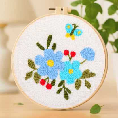 Delicate blue flowers bloom softly against a white canvas, accented by bright red berries and a fluttering butterfly above. The gentle color harmony evokes a sense of calm and freshness — like a quiet whisper of spring in full bloom.