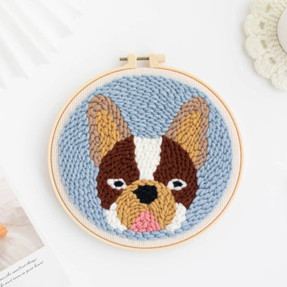 Crocheted dog portrait in a wooden hoop on a light background