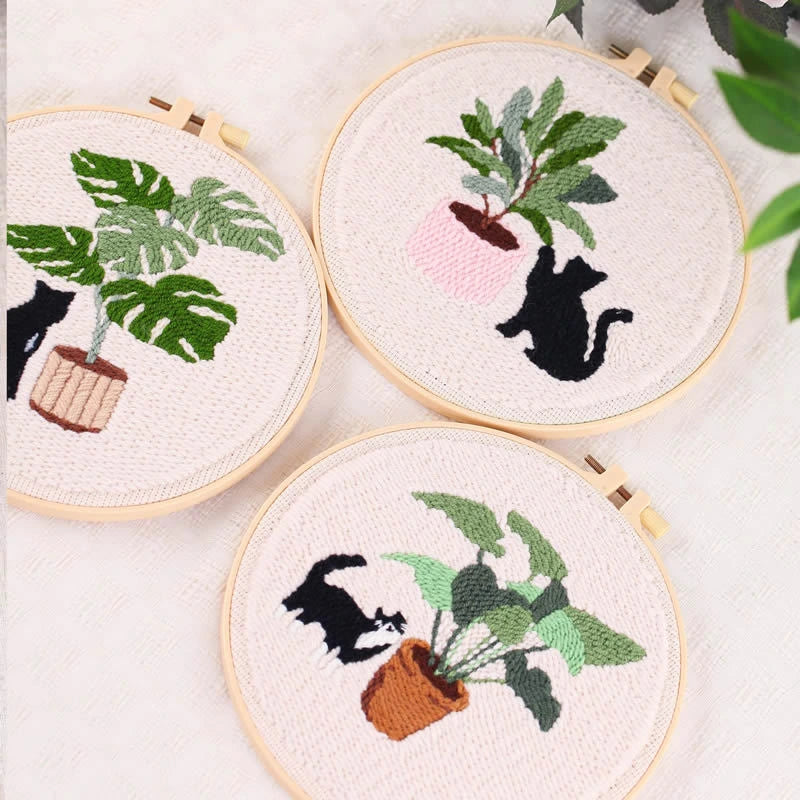 Three Punch Needle hoops with cats and plants on a white background