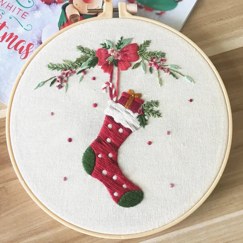 This delightful embroidery design features a classic red Christmas stocking filled with festive gifts and candy canes, tied with a cheerful bow and surrounded by holly leaves and berries. The vibrant red and green tones bring the spirit of Christmas to life — perfect for handmade décor or as a creative holiday gift.