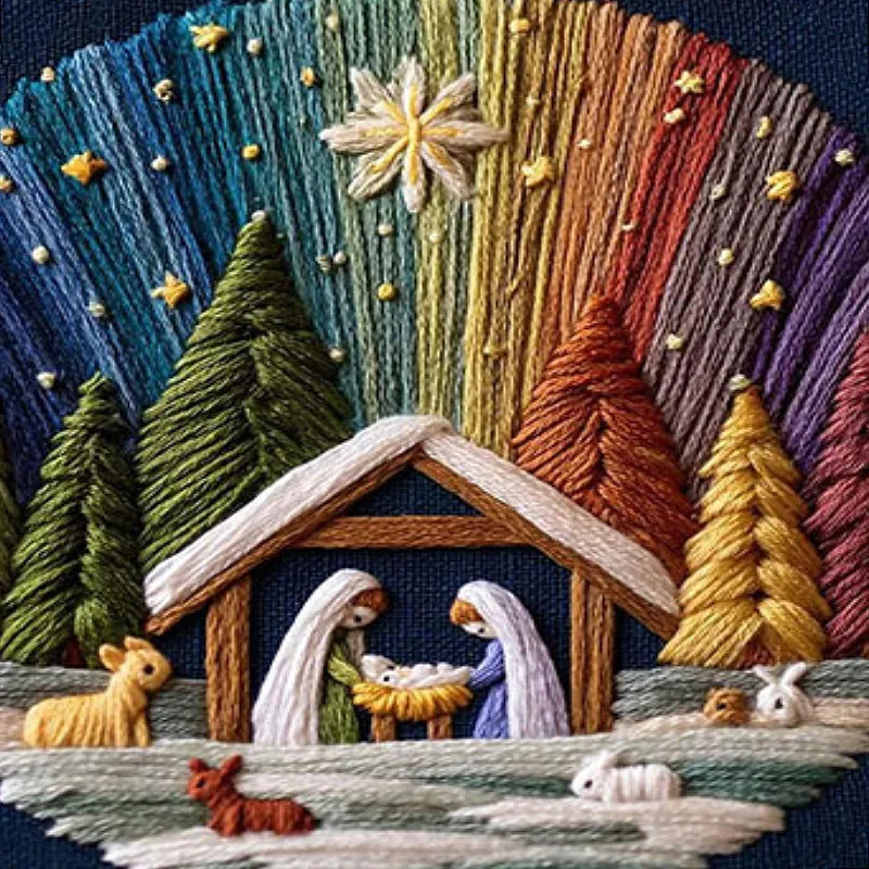 Embroidered nativity scene with stable, Mary, Joseph, and baby Jesus surrounded by trees and animals.