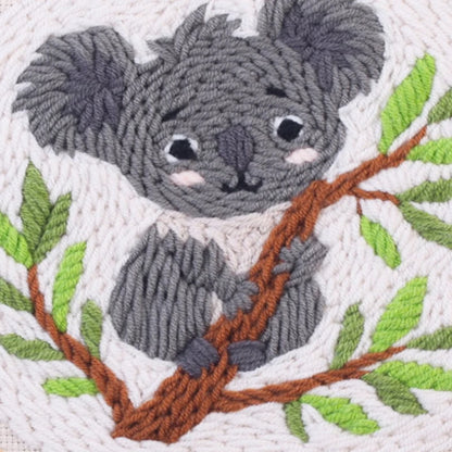 Embroidered koala on a branch with leaves