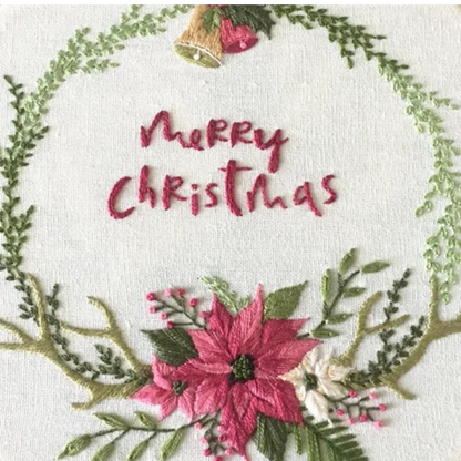 Embroidered Christmas design with 'Merry Christmas' text, poinsettias, and a bell.