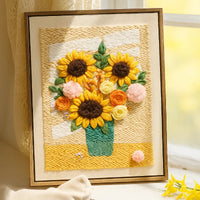 Framed woven art piece with sunflowers and flowers on a textured background
