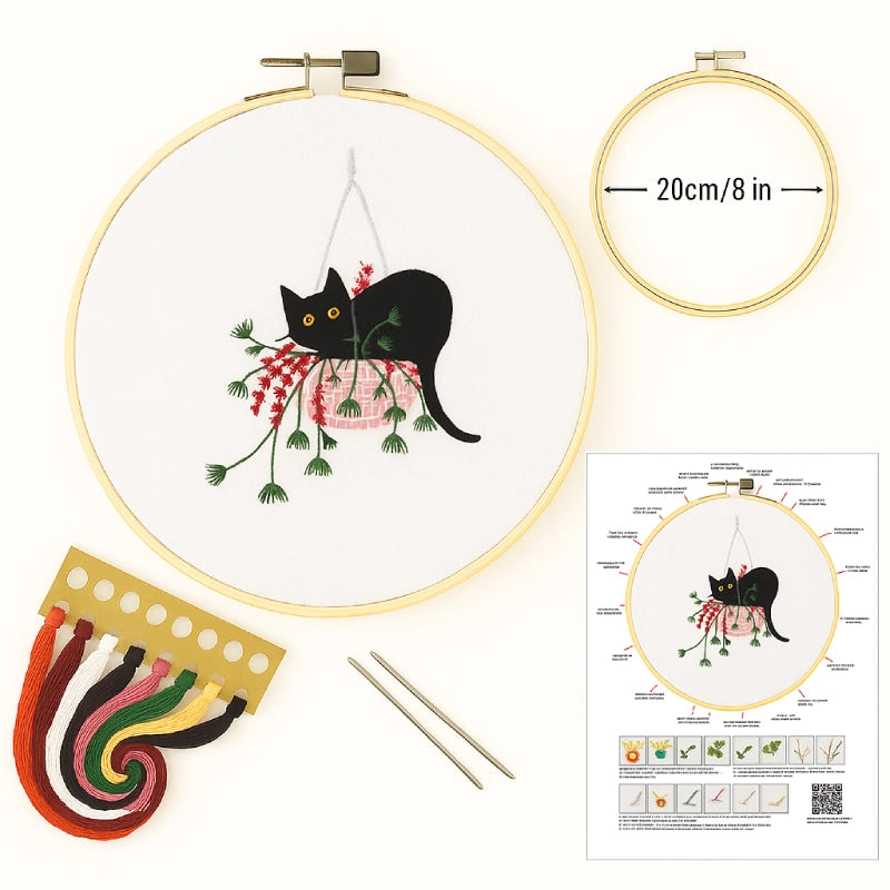 Embroidery kit with hoop, thread, and pattern guide featuring a black cat design.