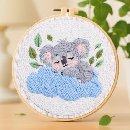 This adorable embroidery design captures a sweet koala peacefully sleeping on a soft blue cloud. The gentle tones of grey, blue, and green create a soothing and dreamy vibe, perfect for relaxation. Easy to stitch and beginner-friendly, it makes a lovely handmade gift or a charming decoration for any cozy space.
