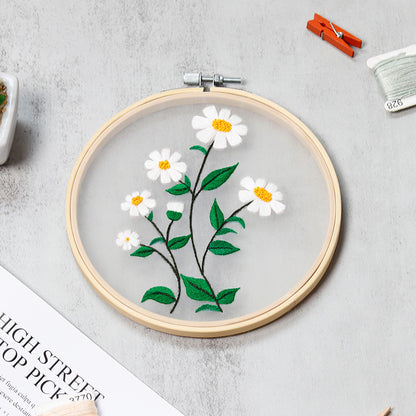 Embroidery hoop with floral design on a gray surface