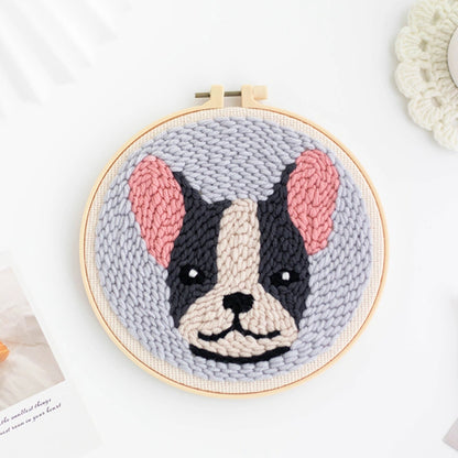 Punch Needle hoop with a knitted dog portrait on a white background