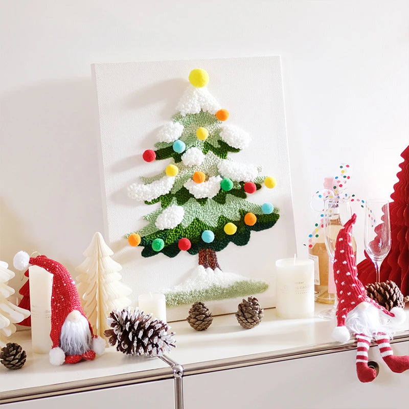 Decorative Christmas scene with a tree, gnomes, and pinecones on a white surface.