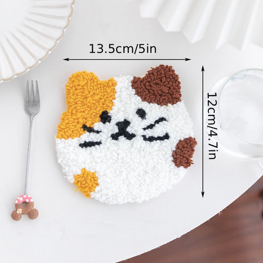 Cat-shaped decorative item with measurements on a white plate with a fork and glass.