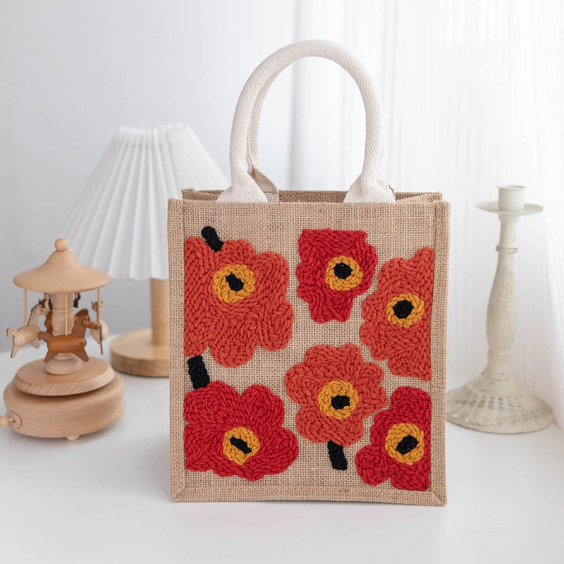 Jute bag with red floral patterns on a white background