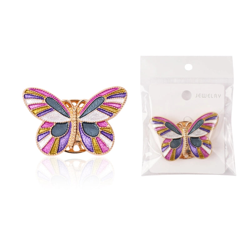 Butterfly-shaped jewelry item with packaging on a white background