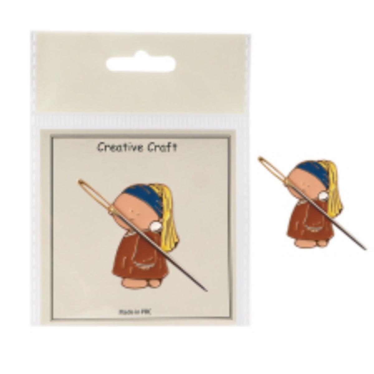 Pin with a design of a person holding a staff, on a 'Creative Craft' branded card.