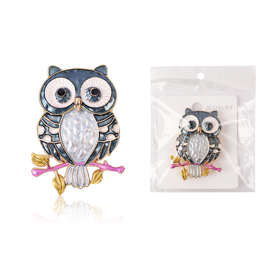 Owl-shaped earrings with a branch on a white background