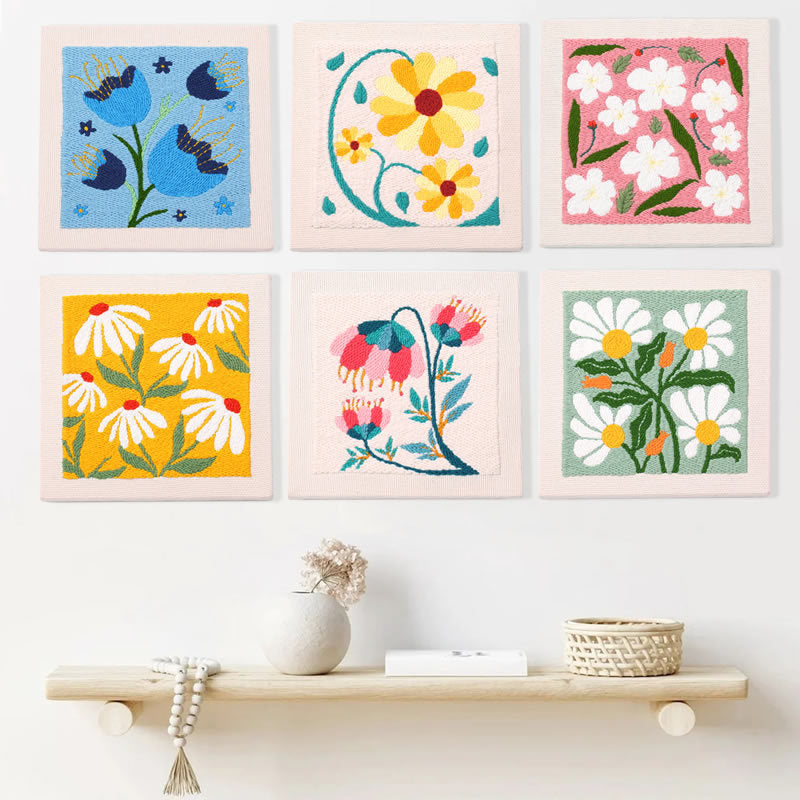 Set of six colorful floral artworks on a wall above a shelf with decorative items.