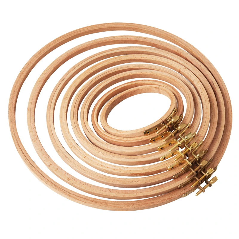 Set of wooden embroidery hoops with metal clamps on a white background