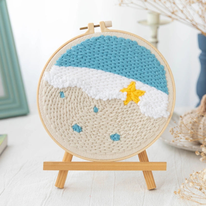 Handmade crochet wall art with a star design on a wooden stand.