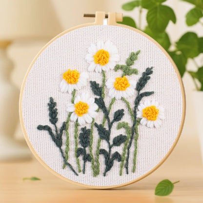 A cheerful design featuring bright white daisies with golden-yellow centers, symbolizing warmth and positivity. Simple yet elegant, this kit is perfect for beginners and anyone who enjoys the calming joy of hand embroidery. A lovely piece to bring a touch of sunshine into your home décor.