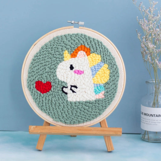 A cute white unicorn with colorful hair and a red heart on a soft green background.