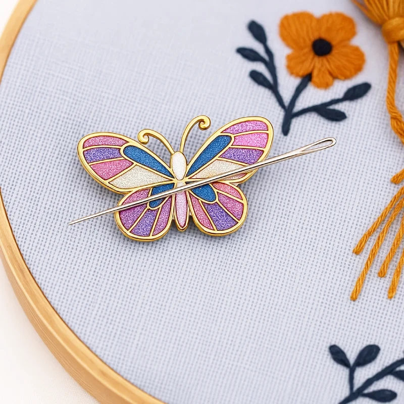 Butterfly-shaped brooch on a piece of embroidery with flowers and tassels.