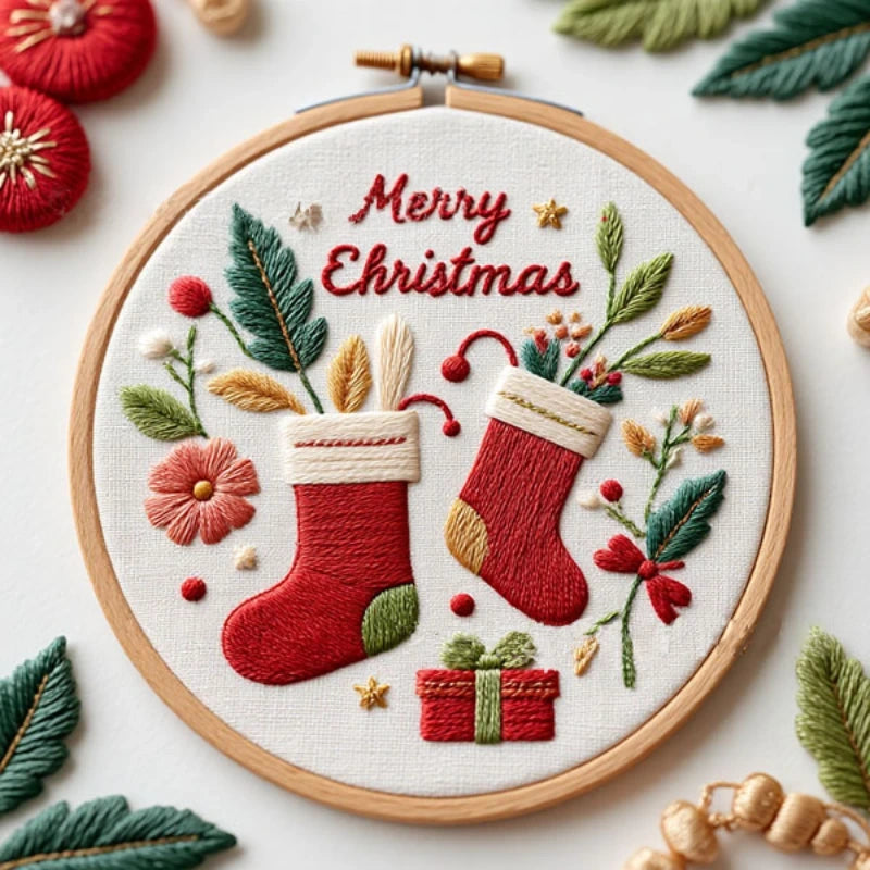 his festive embroidery design features two charming red Christmas stockings filled with greenery, candy canes, and little gifts. Surrounded by delicate flowers and stitched with the warm message “Merry Christmas,” it perfectly captures the joy and coziness of the holiday season.