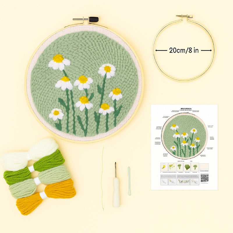 Embroidery hoop with floral design, yarn skeins, a crochet hook, and a pattern sheet on a light yellow background.