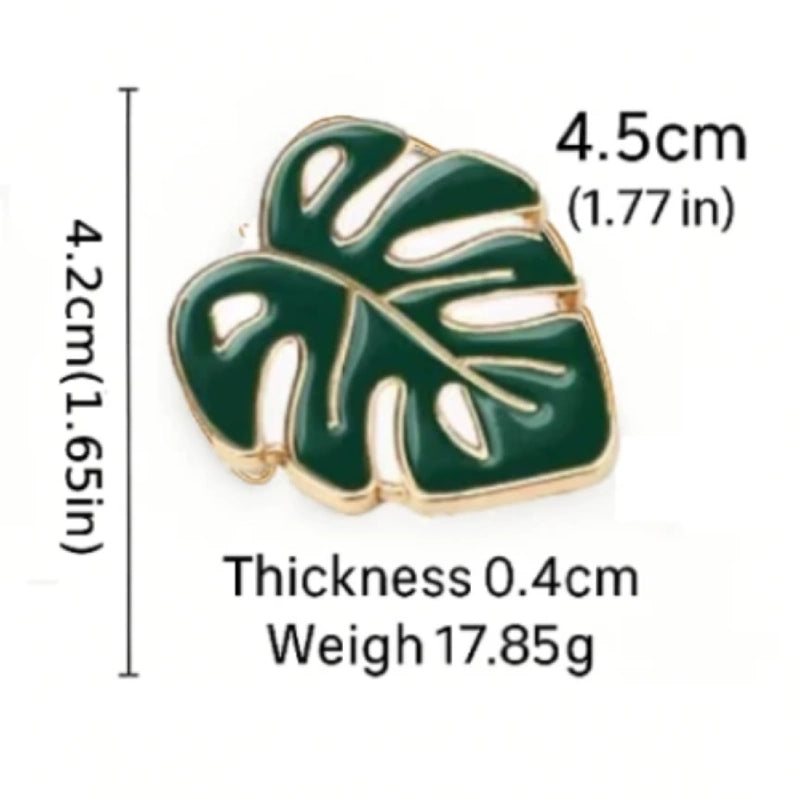 Green leaf-shaped pin with measurements on a white background