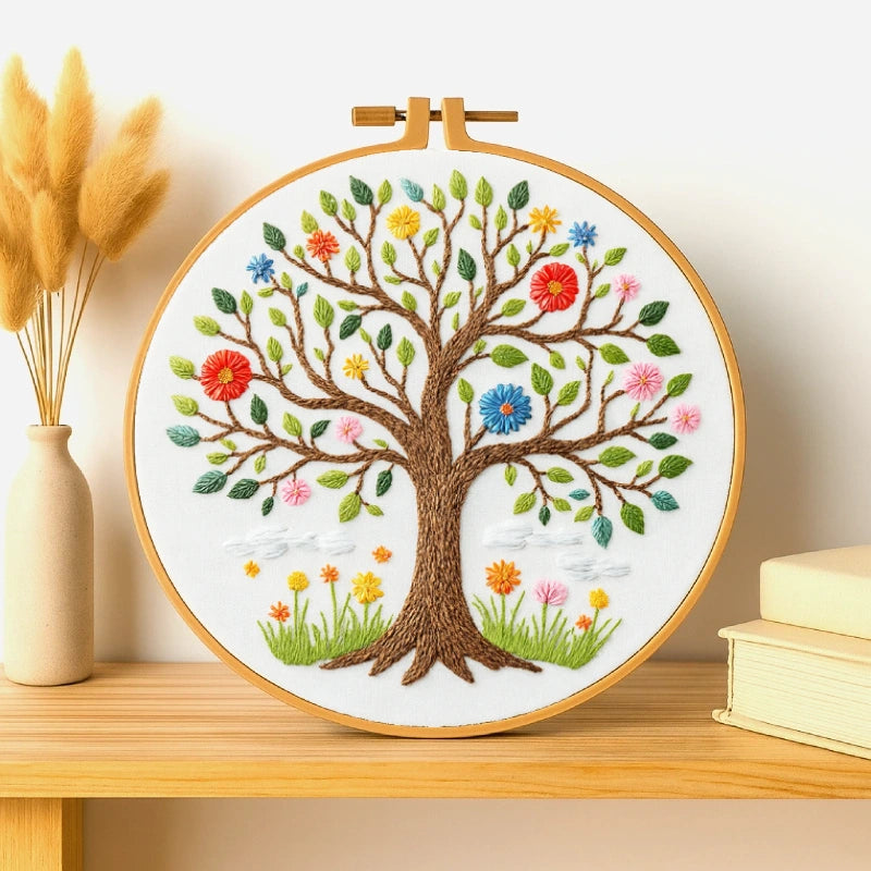 This elegant embroidery features a beautifully detailed tree of life, with colorful blossoms and leaves symbolising the changing seasons. The brown trunk and branches are richly textured, while the flowers in shades of red, yellow, pink, and blue add a lively, cheerful touch. Perfect for home décor, this design brings a sense of growth, balance, and natural beauty to any space.