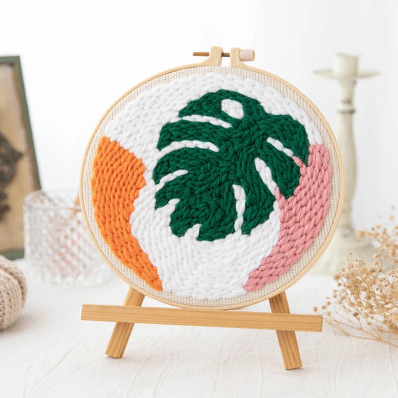 Punch Needle hoop with a leaf design on a white background