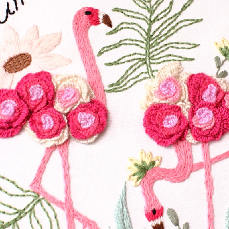 Two pink flamingo with floral details on a white background.